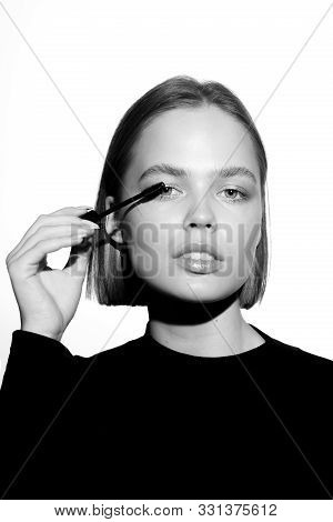 Epic Promotional Portrait Of A Girl With Applicator And Mascara Brush. Black And White Minimalistic 