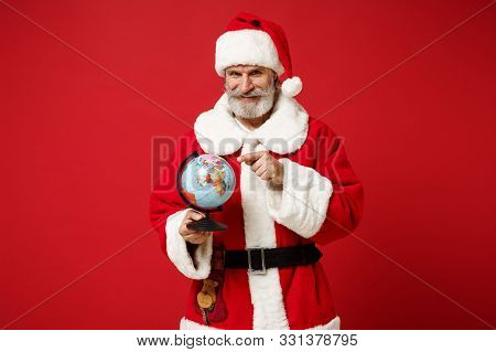 Smiling Elderly Gray-haired Mustache Bearded Santa Man In Christmas Hat Posing Isolated On Red Backg