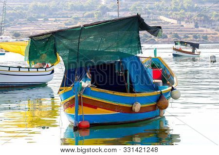 Multicolored Fishing Boats Luzzu With Eyes In The Harbor. Marsaxlokk. Malta.