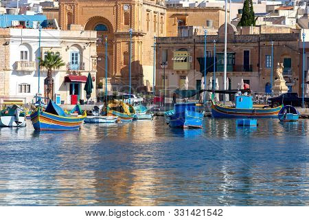 Multicolored Fishing Boats Luzzu With Eyes In The Harbor. Marsaxlokk. Malta.