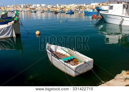 Multicolored Fishing Boats Luzzu With Eyes In The Harbor. Marsaxlokk. Malta.
