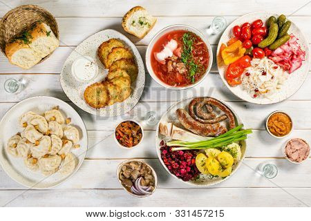 Selection Of Traditional Ukrainian Food - Borsch, Perogies, Potato Cakes, Pickled Vegetables, Top Vi