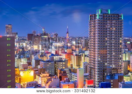 Sapporo, Hokkaido, Japan downtown city skyline over Chuo Ward towards the tower at night.