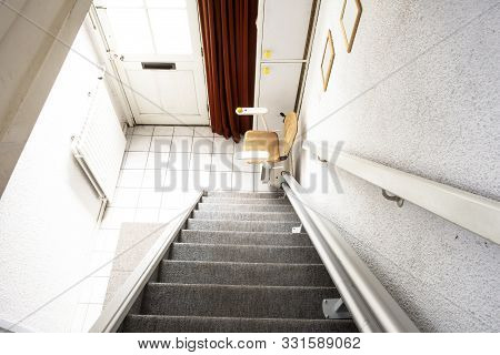 Automatic Stair Lift On Staircase Taking Elderly People And Disabled Persons Up And Down In A House