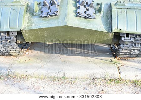 Tank Wheels Close-up. Iron Tracks Of A Heavy Military Tank. Iron Caterpillars And Wheels Of A Milita