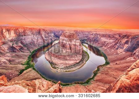 Vivid dramatic sunset over Horseshoe Bend, a famous meander on river Colorado near the town of Page. Arizona, USA