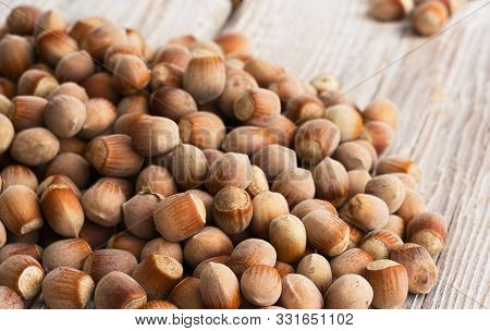 Natural Organic Hazelnut Scattered On A Wooden Vintage Background. Close-up. Healthy Eating Concept.