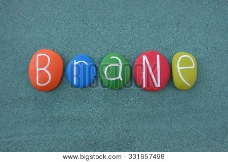 Brane, Male Given Name Composed With Multi Colored And Carved Stone Letters Over Green Sand