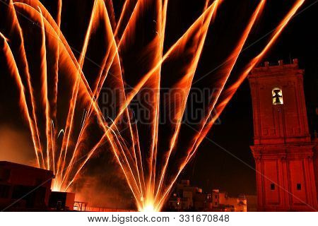 Colorful Fireworks In Pyromusical Show Next To The Bell Tower Of Santa María Church In Elche