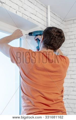 Pvc Windows Installation Worker. Blinds Installation In Appartment. Toned.