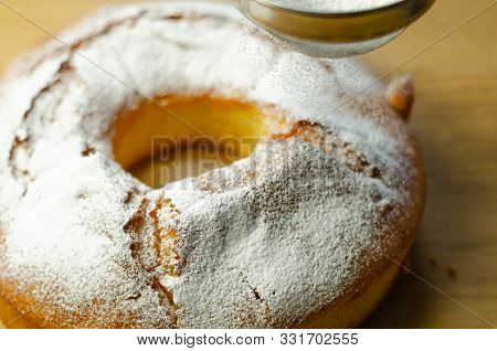 Madeira Ring Loaf Cake Decorated With Powdered Sugar From A Strainer