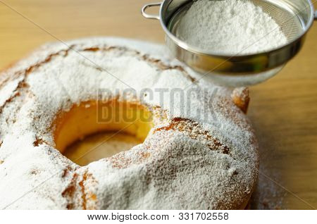 Madeira Ring Loaf Cake Decorated With Powdered Sugar From A Strainer