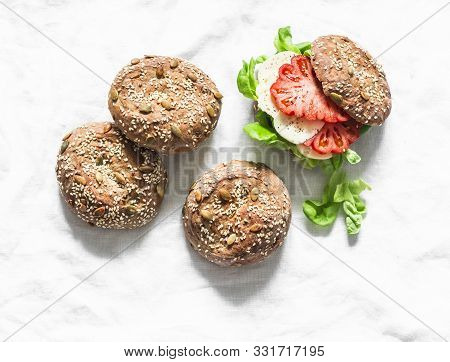Multigrain Multiseed Fitness Buns And Green Salad Tomato Homemade Cheese Sandwich On Light Backgroun