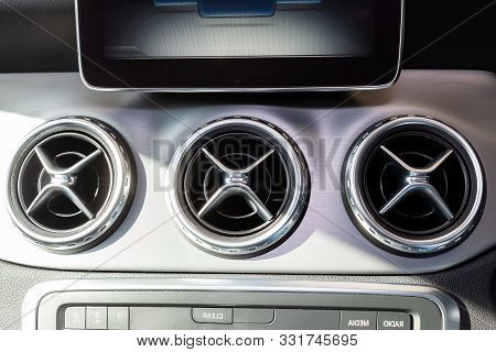 A Close-up View Of A Part Of The Interior Of A Modern Luxury Car With A View Of The Ventilation Chro