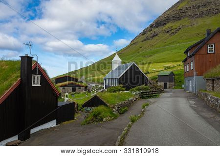 Bour Village. Typical Grass-roof Houses And Green Mountains. Vagar Island, Faroe Islands. Denmark. E