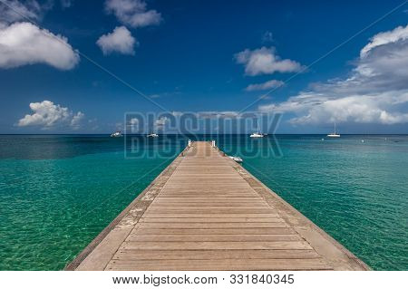 Wood Pontoon And Turquoise Water At Petite Anse In Martinique