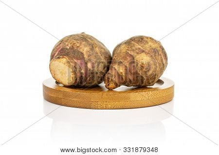 Group Of Two Whole Fresh Brown Jerusalem Artichoke On Bamboo Coaster Isolated On White Background