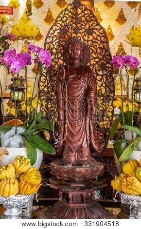 Da Nang, Vietnam - March 10, 2019: Chua An Long Chinese Buddhist Temple. Brown-maroon Wooden Guan Yi