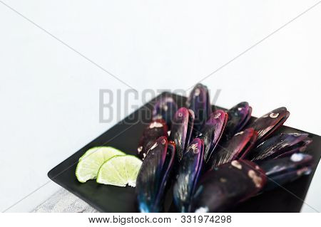 Healthy Pink Exotic Mollusk Food On Black Platge, Tasty Appetizer At Luxurious Restaurant