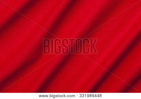 Close-up Fragment Of Crumpled Red Polyester Fabric. Concept Of High-quality Raw Materials For Clothi