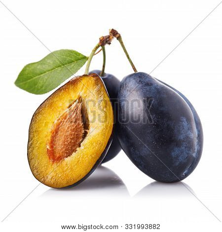 Useful Fruits: Three Ripe Prunes Isolated On White Background