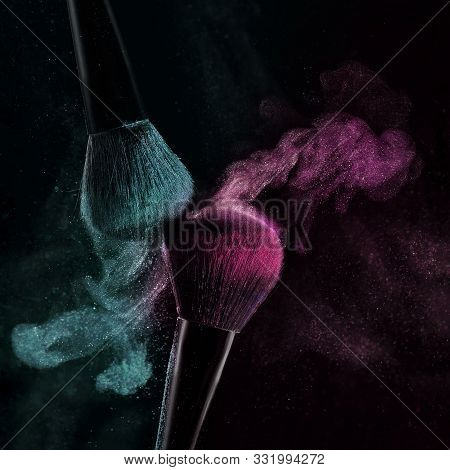 Makeup Concept With A Single Red Makeup Brush Shaking And Applying Green Powder. Colorful Dust Explo