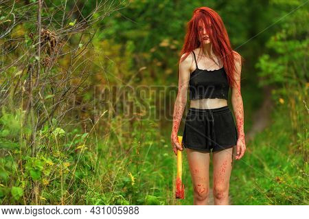 Red-haired Girl With Bloody Axe At Path In Summer Forest
