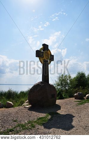 Cross On A Stone Base. The Inscription On The Cross In Old Church Slavonic. View Of Lake Nero. Augus