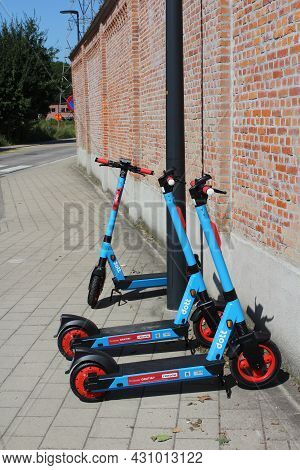 Aalst, Belgium, 25 August 2021: A Group Of 'dott' Electric Scooters Parked On A Pavement In Aalst. T