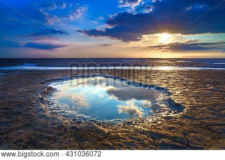 Wadden Sea In The Netherlands During Sunset With Wid Angel View And Colorful Clouds.