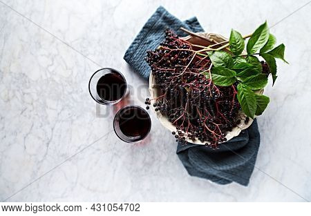 Freshly picked Elderberries and Elderberry Juice. Top view. Copy space
