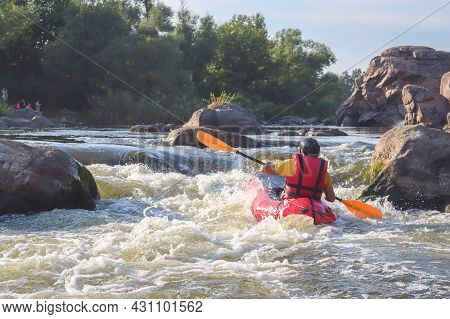A Man Rowing Inflatable Packraft On Whitewater Of Mountain River. Concept: Summer Extreme Water Spor