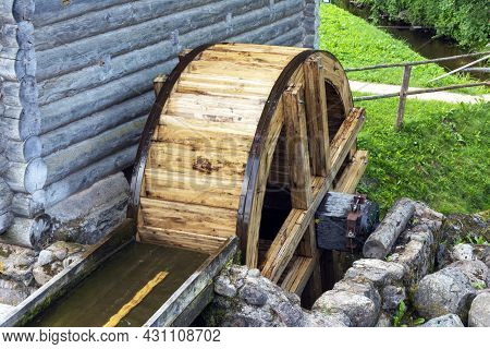 The Wheel Of An Old Water Mill. A Village Water Mill, The Wheel Of Which Rotates Under The Influence