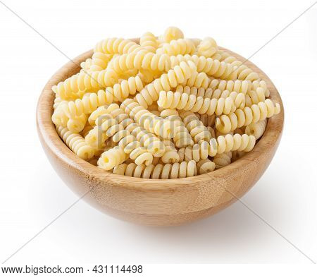 Uncooked Fusilli Corti Bucati Pasta In Wooden Bowl Isolated On White Background With Clipping Path