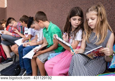 Group Of Elementary School Kids Having An Outdoor Class. Back To School