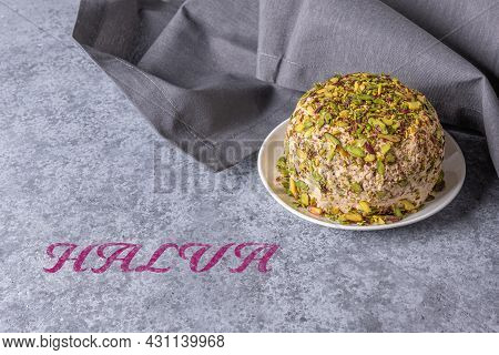 Halva With Pistachios On Gray Stone Background With Gray Linen Napkin On Side And Halva Pink Text. T