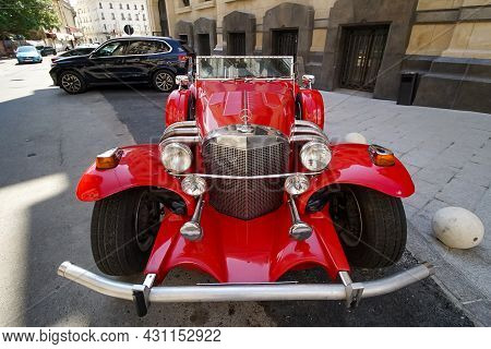 Bucharest, Romania - August 19, 2021: A Red Excalibur 1970s Ss Car Is Parked In Front Of The Marmoro