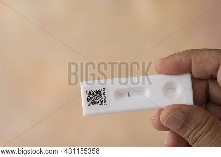 Hand Holding The Covid 19 Rapid Antigen Test Kit With Negative Result. Selective Focus Points.