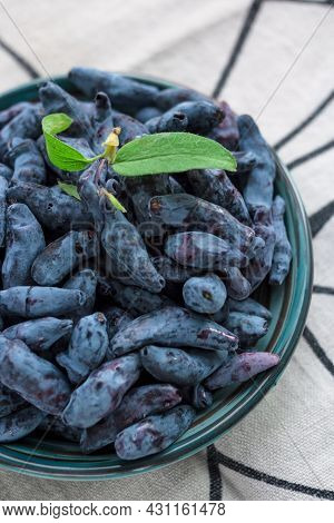 Closeup Fresh Blue Honeysuckle Or Haskap Berry On Plate On Fabric Napkin, Summer Fruit, Natural Orga
