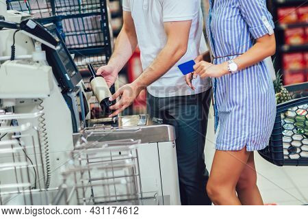Couple With Bank Card Buying Food At Grocery Store Or Supermarket Self-checkout