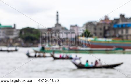 Blurry Defocused Image Of A Busy River With Passing Wooden Boats And Trawlers In Bangladesh
