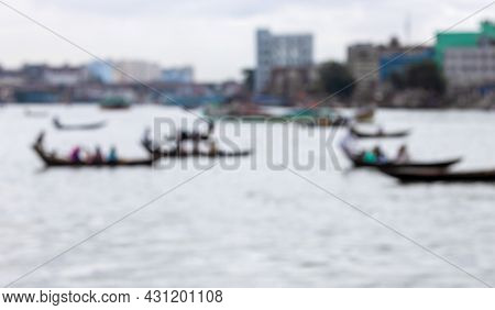Defocused Blur Image Of Passing Wooden Boats And Trawlers Over The River In Bangladesh
