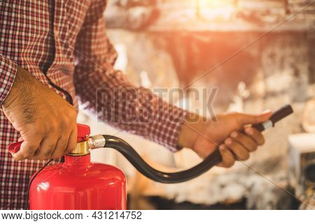 Close Up Hand Fireman Using Fire Extinguisher Fighting.