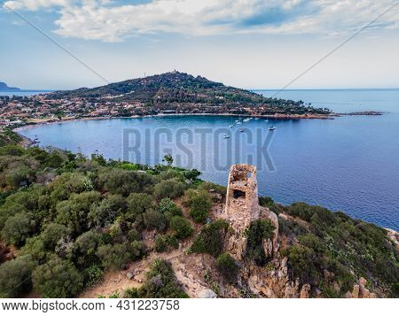 Arbatax, Italy. July 20, 2021: San Gemiliano Fortress Tower On The Rocky Coast On The Blue Sea. Sard