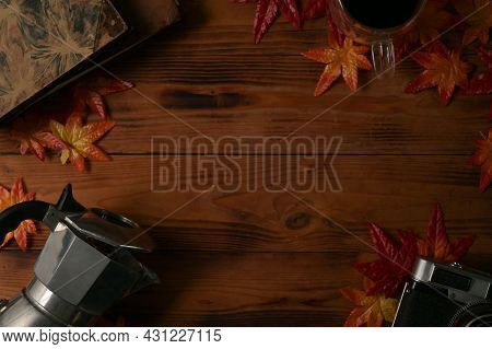 Mock Up And Top View With Wooden Table Decorated By Moka Pot, Camera, Maple Leaves, Black Coffee And