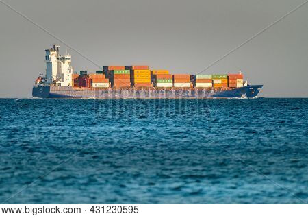 Hek, Poland - 08.01.2021: Big Cargo Container Ship Fully Loaded On Its Way Across The Baltic Sea In 
