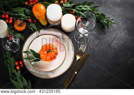 Autumn Table Setting With Plate, Pumpkin And Candles.