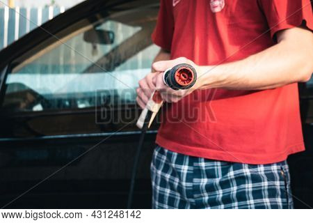 Car Wash. A Man Holds A Karcher Sink In His Hands. Close-up