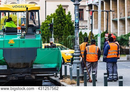Workers In Overalls In An Autumn Morning Repair The Street On The Main Boulevard Victoriei (calea Vi