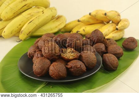 Rice Fritters Made With A Batter Of Rice Flour, Banana, Jaggery And Roasted Coconut Pieces. Made In
